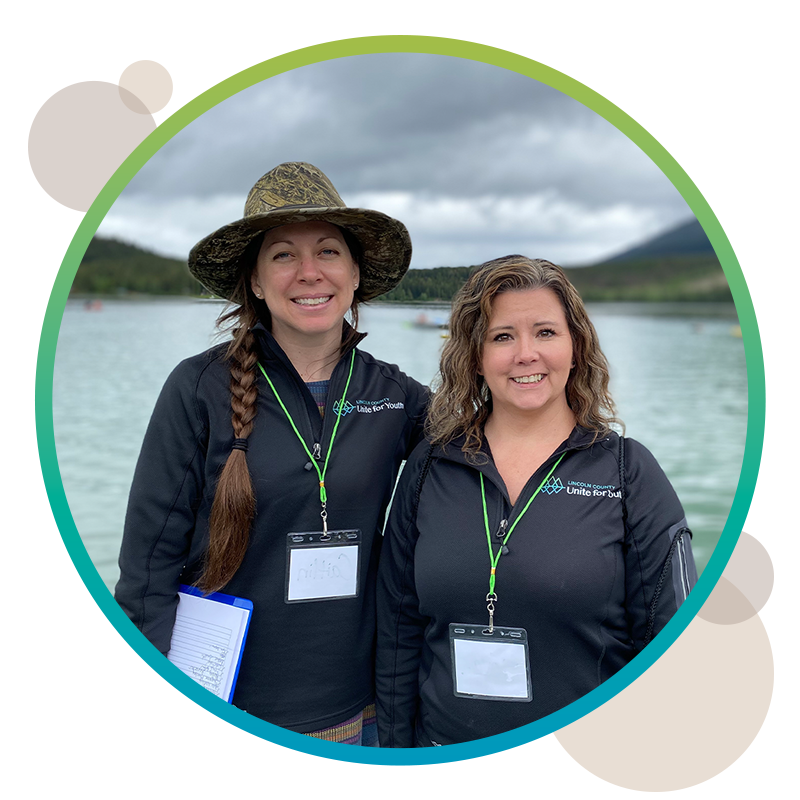 Two LC Unite for Youth team members standing next to a lake