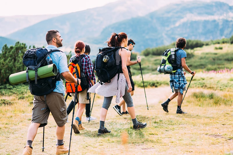 Group of teens hiking with youth leader